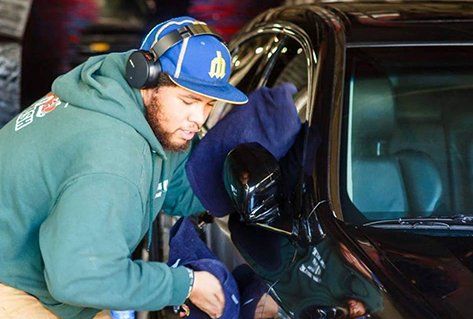 man cleaning car